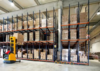 Yellow fork lifter work in big warehouse